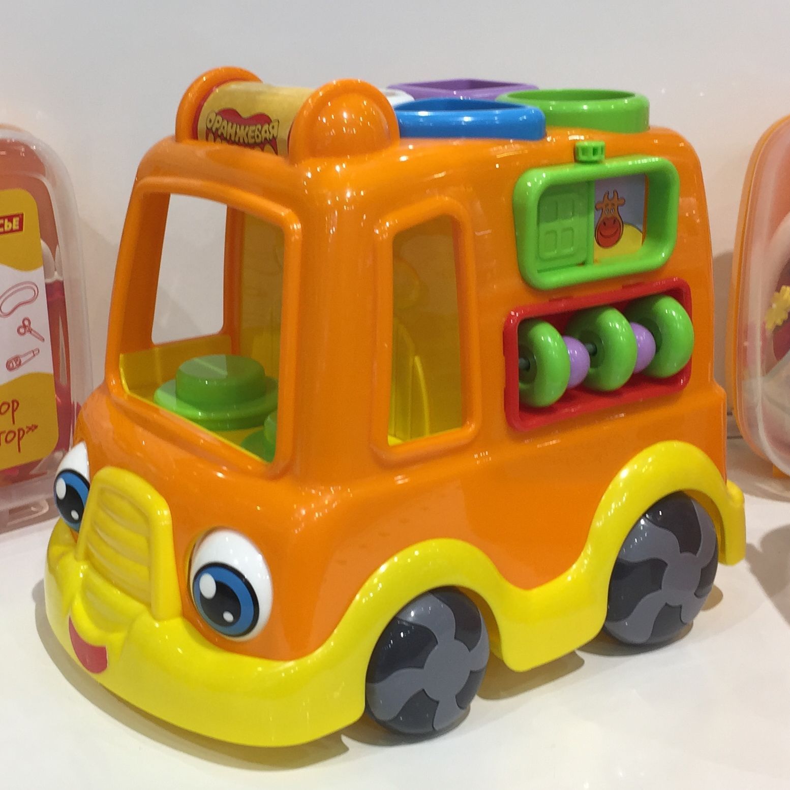 Игрушка машинка с вращением глазок - развивающий центр моторики для малышей оранжевая - 25 см